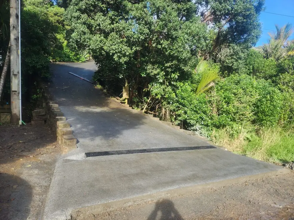After: Concrete driveway installation and retaining wall in Titirangi, West Auckland